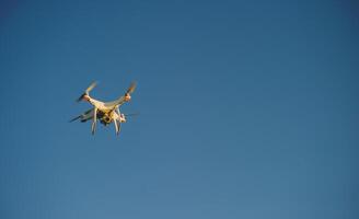 Drones take aerial photos of tourists and professional photographers. Flying photography equipment.