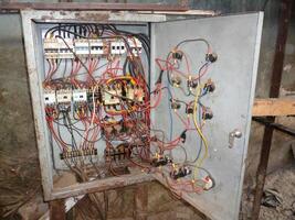 A box with wires and electrical equipment inside photo