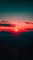 The sun sets over the mountains in this photo