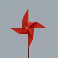 A red pinwheel on a stick against a gray background photo