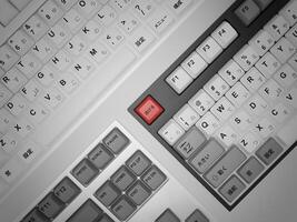 A keyboard with a red key on it photo