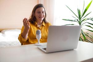 30s female teacher teach by call explain educational material to trainee distantly seated on couch in living room at home. Friends communicating use videoconference app concept, pc screen view photo