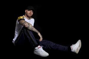 portrait of young active rapper in the studio photo