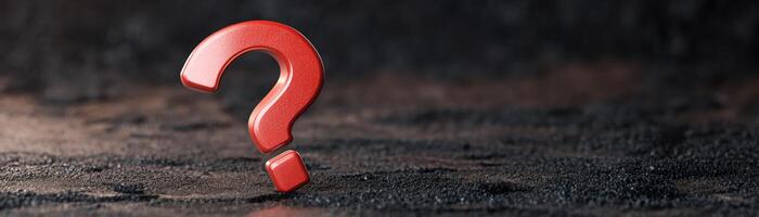 Red question mark on a dark textured background. Conceptual image for curiosity, confusion, inquiry, and asking questions. photo