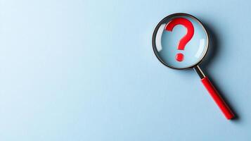 Magnifying glass with red question mark on light blue background, symbolizing search, inquiry, investigation, and curiosity. photo