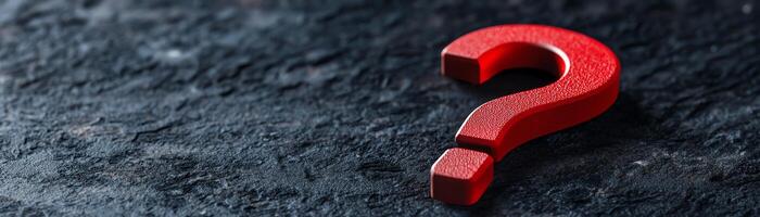 Red question mark on a dark textured surface. Symbol of inquiry, uncertainty, and problem-solving in a conceptual image. photo