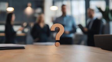 Blurred office background with focus on a question mark, symbolizing uncertainty, decision-making, and business discussions. photo