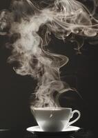 Steaming hot cup of coffee in a white ceramic mug against a dark background photo