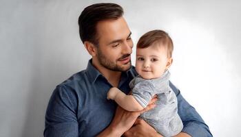 father with his beautiful son on his lap on a white background photo