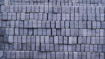 Pile of paving block, grey abstract textured background, copy space photo