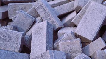 Pile of paving block, grey abstract textured background, copy space photo