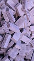Pile of paving block, grey abstract textured background, copy space photo