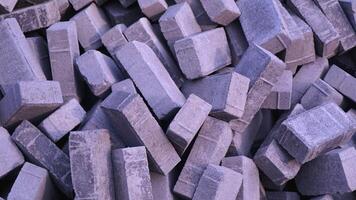 Pile of paving block, grey abstract textured background, copy space photo