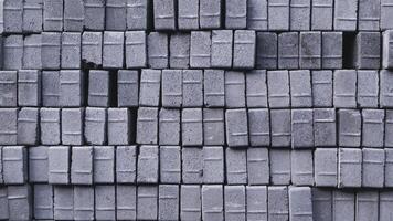 Pile of paving block, grey abstract textured background, copy space photo