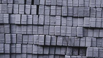 Pile of paving block, grey abstract textured background, copy space photo