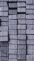 Pile of paving block, grey abstract textured background, copy space photo