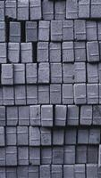Pile of paving block, grey abstract textured background, copy space photo
