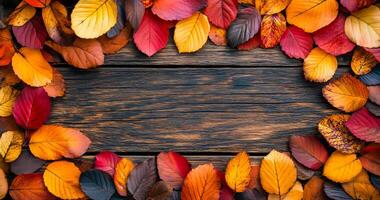 Autumn leaves on a wooden table. Vibrant autumn leaves in various colors surround a rustic wooden surface, showcasing the beauty of fall foliage. photo