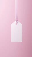 Rectangular white blank paper tag label price tag with hanging rope isolated pink photo