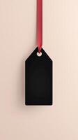 Rectangular black blank paper tag label price tag with hanging rope isolated pink photo