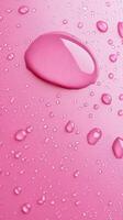 Waterdrop bubble splashing rounded on pink blurred background photo