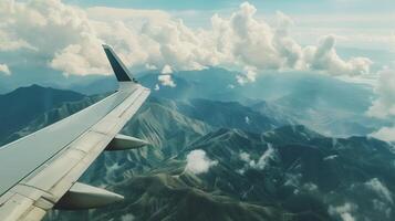 Landscape view blue sky, mountain and clouds from window plane travel journey photo