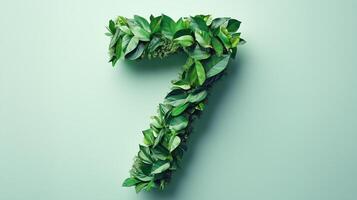 The number 7 is framed by a series of green leaves solid background photo