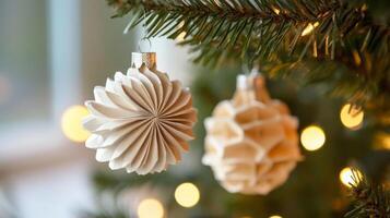 White Paper Christmas Ornaments Hanging on a Christmas Tree Branch photo