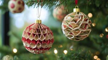 Two Paper Christmas Ornaments Hanging on a Christmas Tree photo