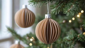 Folded Paper Ornament Hanging from a Christmas Tree Branch photo