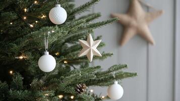 White Ornaments and a Wooden Star on a Christmas Tree photo