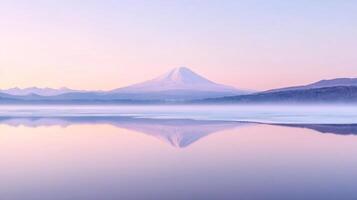 A Serene Reflection of Mount Fuji with a Misty Lake and Pale Sky photo