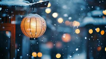 Illuminated Lantern Hanging in Snowy Winter Night photo