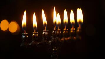 Burning Candles on a Menorah in the Dark photo