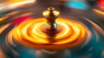 A Golden Object Rotating on a Surface with Blurry Orange and Blue Hues photo