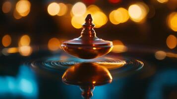 A spinning golden top with a blurred background of warm lights photo