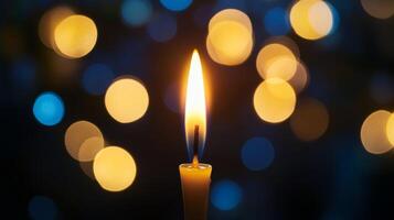 A Single Candle Burning with Bokeh Lights in the Background photo