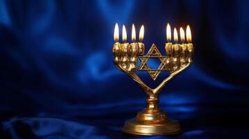 Golden Menorah with Burning Candles and Star of David on Blue Satin photo
