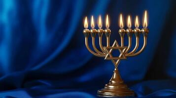 Golden Menorah with Lit Candles on a Blue Background photo