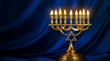 A Golden Menorah with Burning Candles on a Blue Fabric Background photo