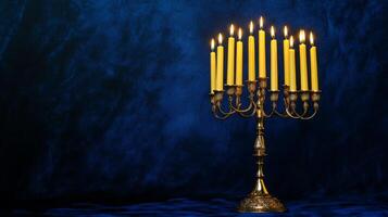 Lit Candles on a Brass Candelabra Against a Blue Background photo