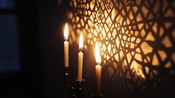 Two Burning Candles Cast Shadows on a Wall photo