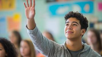 A young man raises his hand to answer a question in a classroom. photo