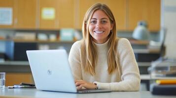 A Smiling Woman Uses a Laptop in an Office Setting photo