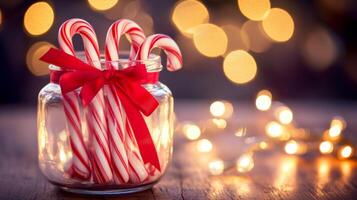 Candy Canes in a Glass Jar with a Red Bow and Christmas Lights photo