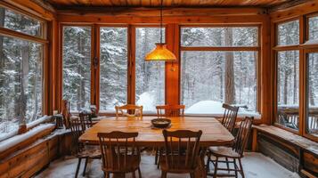 Wooden Dining Table and Chairs in a Cabin with Snow-Covered Trees Outside photo