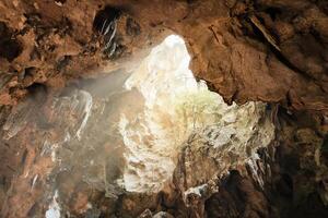 The mouth of the Khao Luang Cave in Phetchaburi with light coming through the top photo
