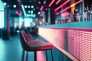 Modern bar with illuminated neon lighting, empty stools and a stylish counter photo
