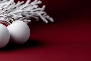 Elegant Christmas decor with snow covered branches on a deep red background photo
