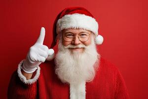 Cheerful Santa Claus in glasses and a white beard points upwards photo
